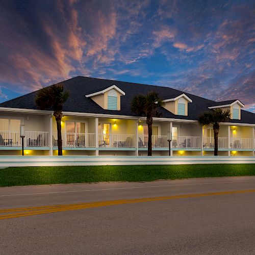 The image shows a large building with a porch, possibly a house or inn, set against a dramatic evening sky.